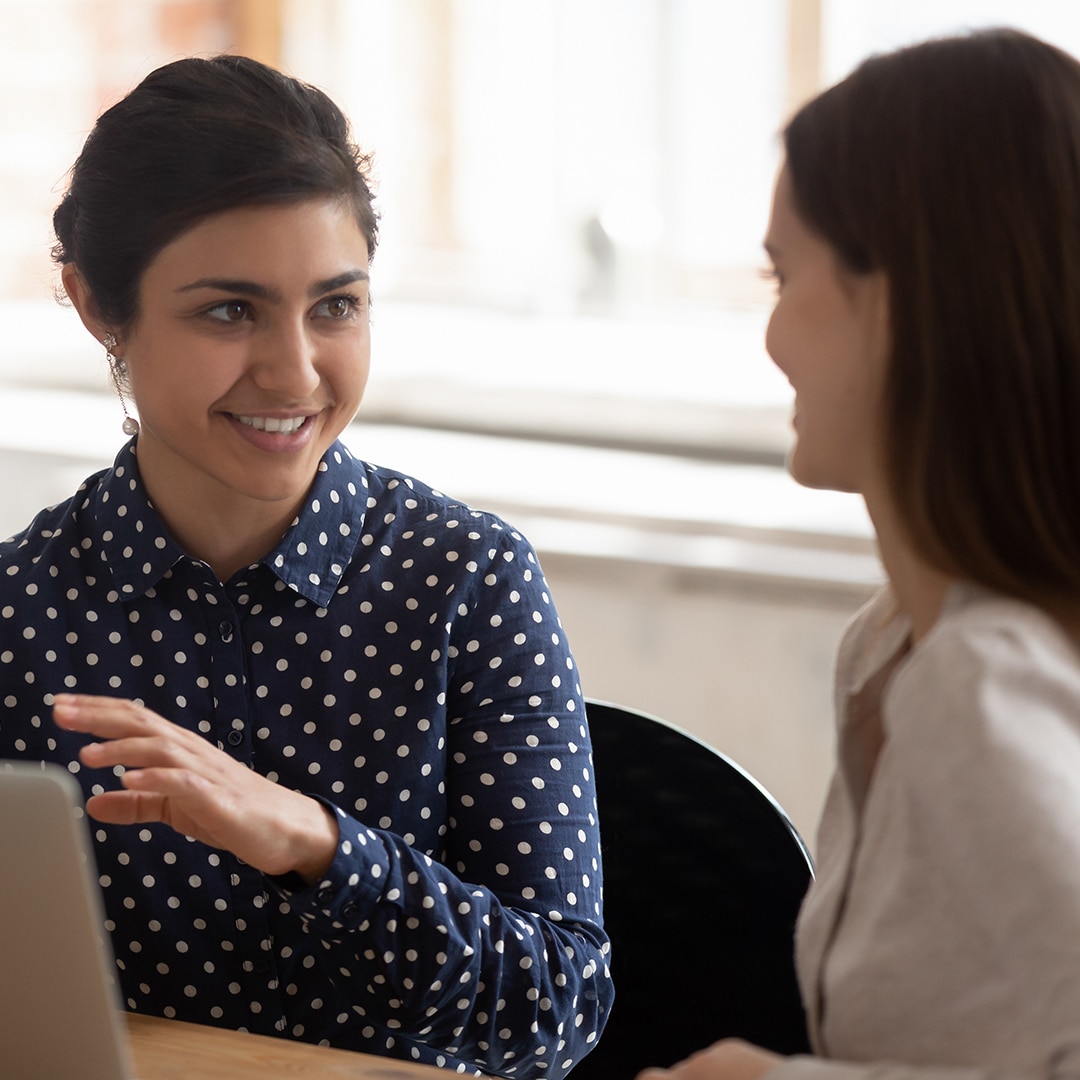 Two girl talking in front of computer - do-over conversation