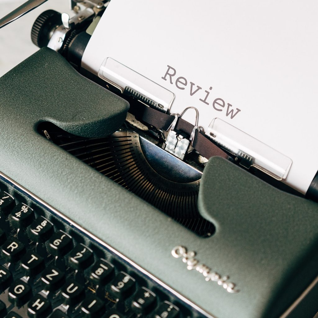 Review typed on a piece of paper in a typewriter