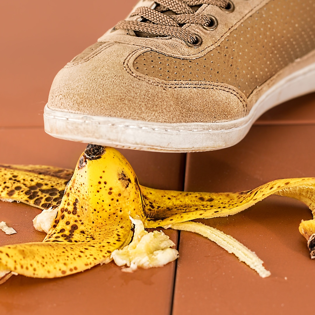 Shoe stepping on banana peel