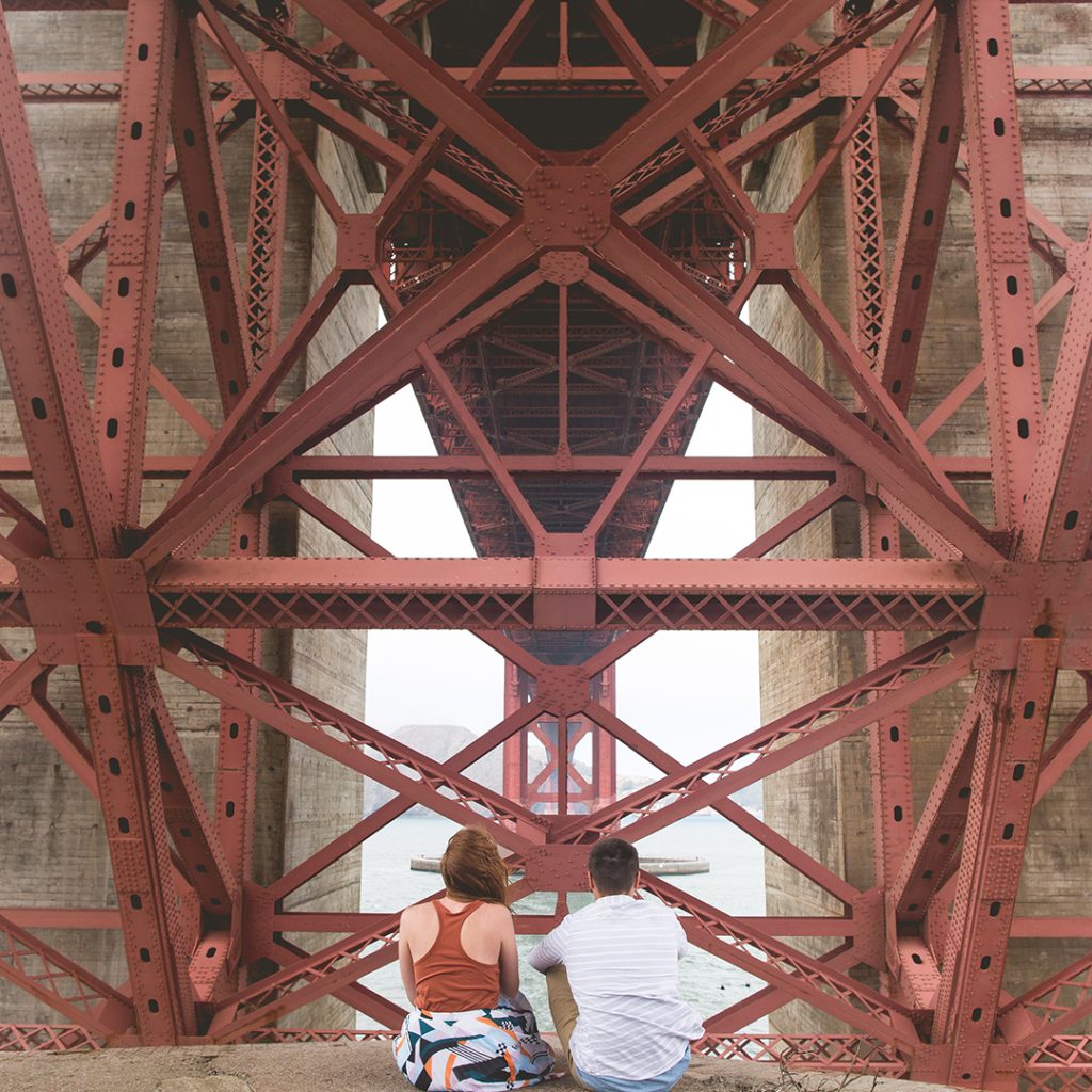 People looking at underside of bridge