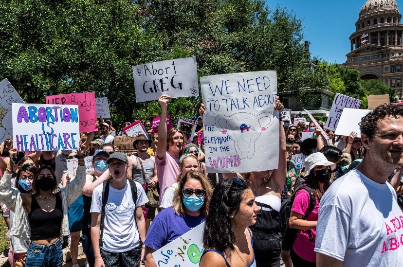 protestors hold abortion is healthcare sign