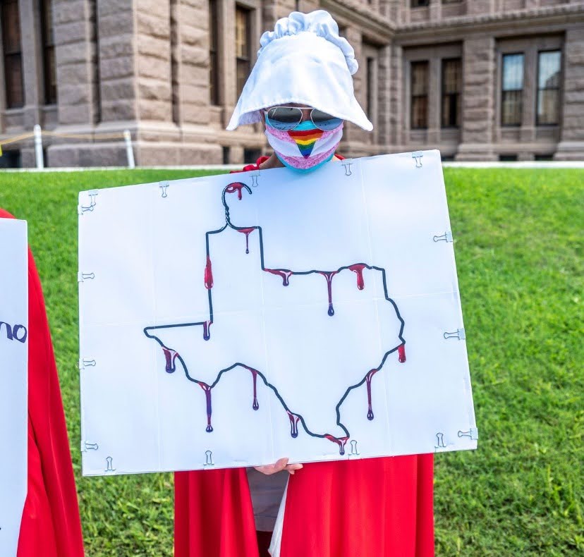 handmaid's tale protesting Texas abortion law coat hanger