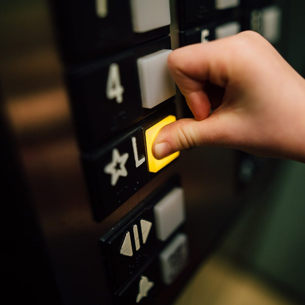 Elevator button being pushed