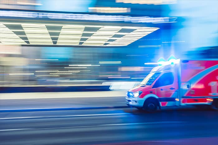 Ambulance going with lights on and blurb background to show it's going fast 