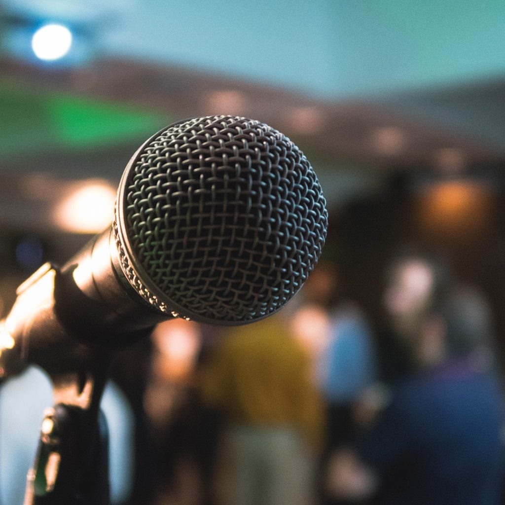 Microphone in forefront and blurred people in background