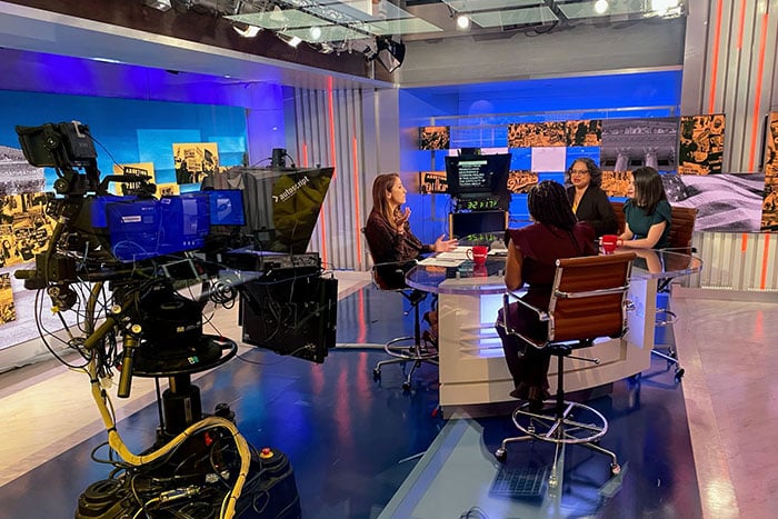 News studio set with four women